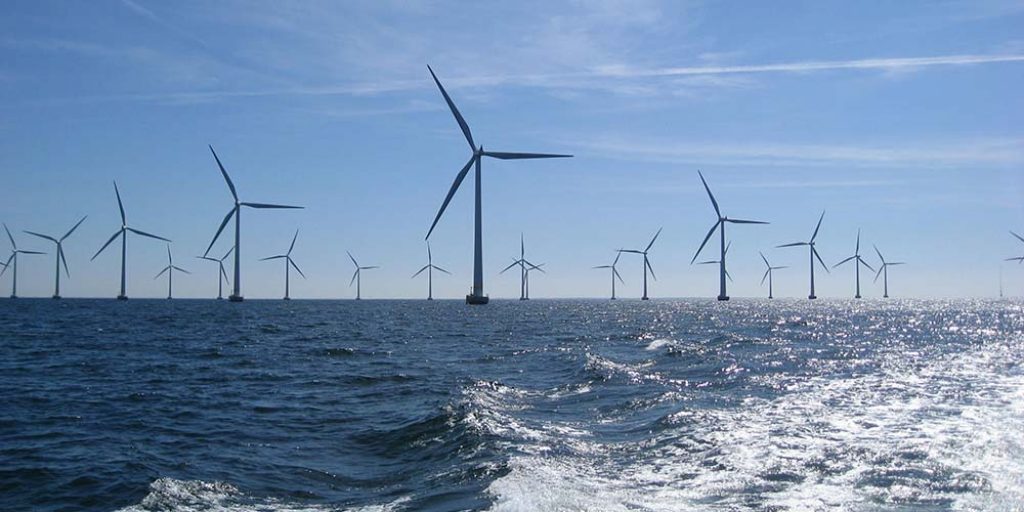 A number of offshore wind turbines at sea