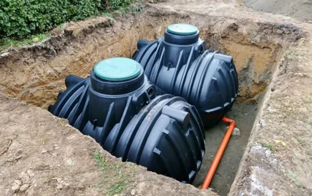 These are rainwater tanks dug into the ground. The water is pumped out of the tank when it's used. 
