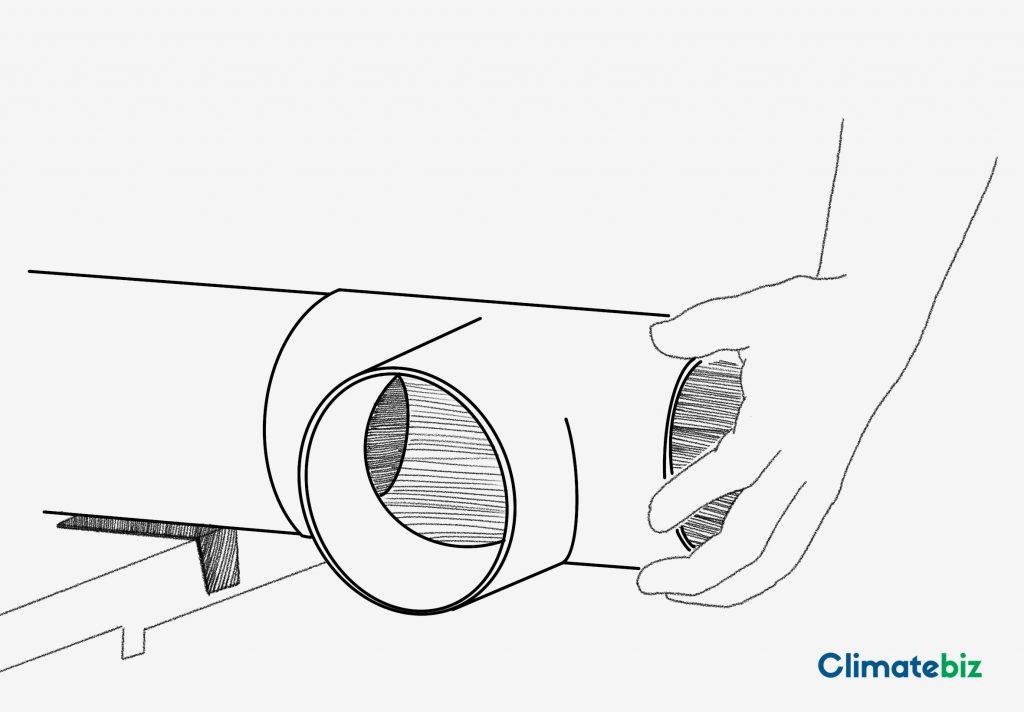 A PVC Tee being fitted to a 4" PVC pipe — DIY rainwater system. 