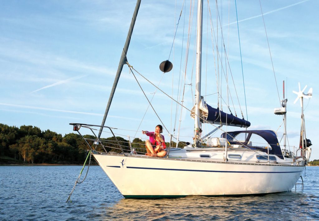 This boat has a wind turbine fixed on the stern — wind turbines for boats.