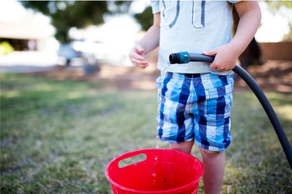 The hose and a bucket analogy for electric vehicle chargers — charging electric car in public.