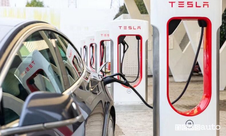 Tesla being charged at Tesla charging station.