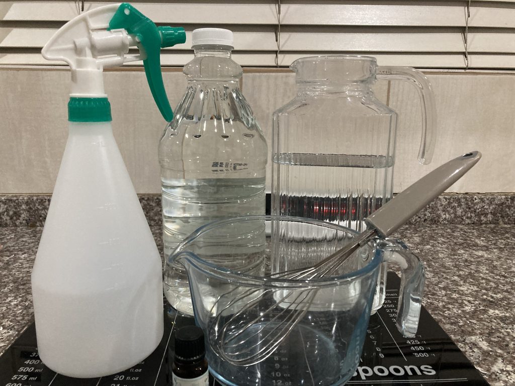 Water, vinegar, and essential oils to make a multi-purpose homemade cleaner.