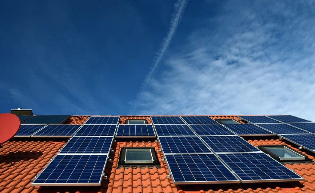 Solar panels on the rooftop of an apartment.  