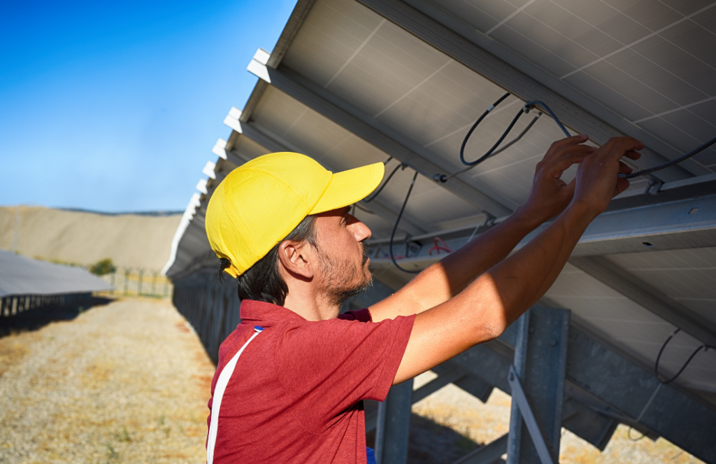 A solar engineer hard at work making sure a solar panel installation meets all the necessary requirements.