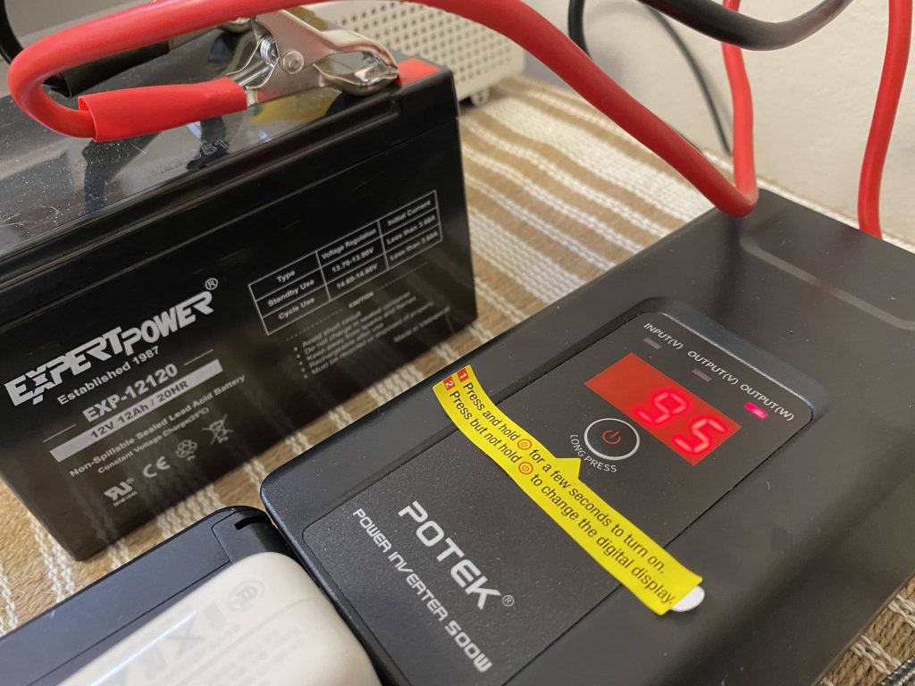 A 500W inverter converting 12V-DC to 120V-AC, delivering 95W worth of power to various electronic loads.