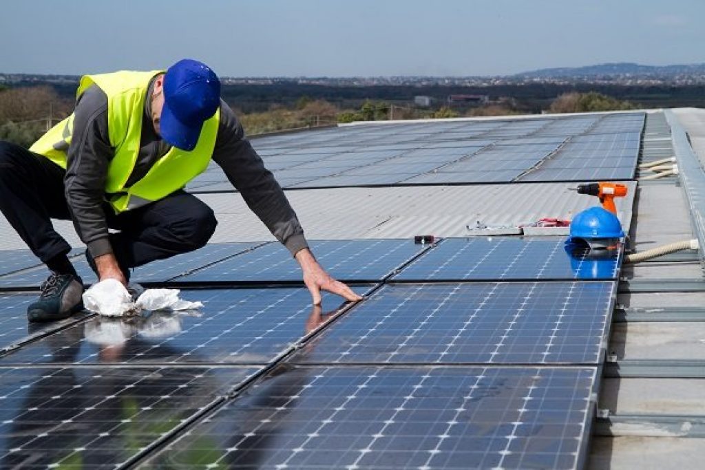 An example of solar panels being cleaned as part of regular maintenance practices.