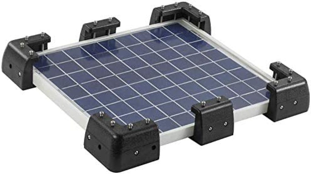 Mounted RV solar panel using drill-free brackets.